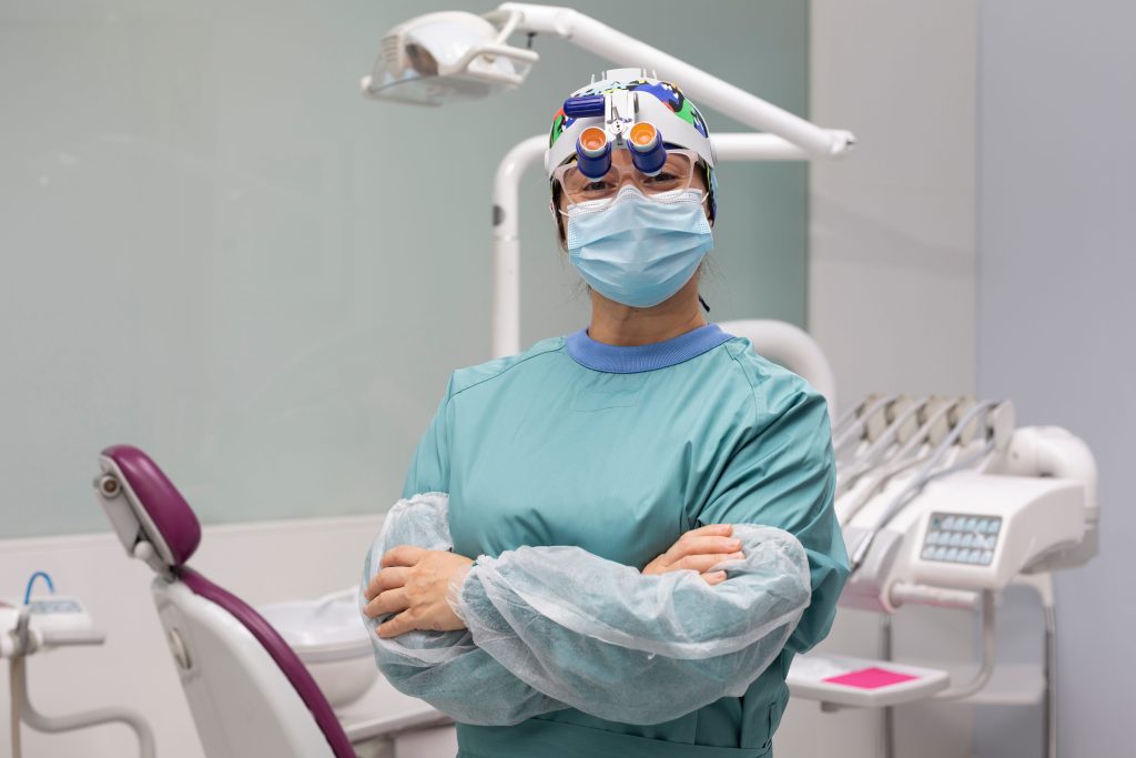 Portrait of female dentist dressed in surgical protective clothing.